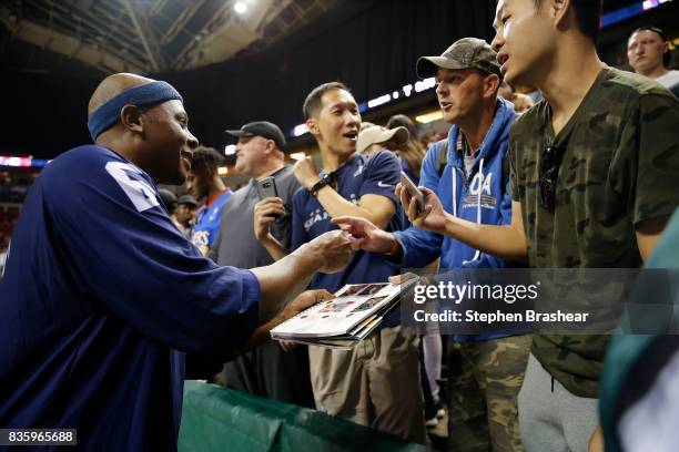 Bonzi Wells of the Tri-State signs autographs for fans in week nine of the BIG3 three-on-three basketball league at Key Arena on August 20, 2017 in...