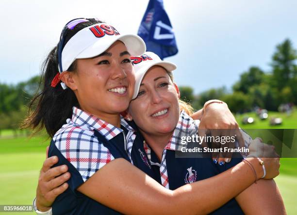 Danielle Kang and Cristie Kerr of Team USA celebrate afterthe final day singles matches of The Solheim Cup at Des Moines Golf and Country Club on...