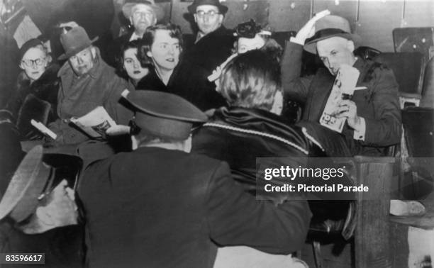 Fans attack NHL president Clarence Campbell during a game at the Montreal Forum, Montreal, Canada, 17th March 1955. The disorder, over Campbell's...