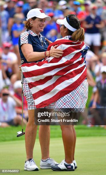 Juli Inkster, Captain of Team USA celebrates with Lizette Salas on the 18th hole during the final day singles matches of The Solheim Cup at Des...