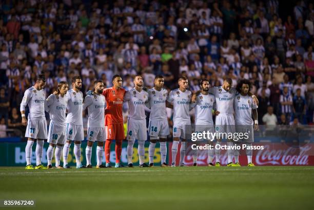 Real Madrid players line up to observe a minute's silence in memory of victims of the terrorist attack in Barcelona this week, during the La Liga...