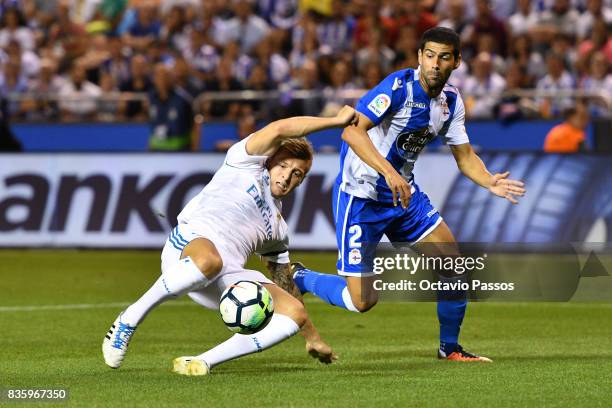 Juanfran of RC Deportivo La Coruna competes for the ball with Toni Kroos of Real Madrid during the La Liga match between Deportivo La Coruna and Real...