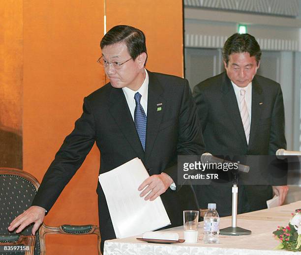 Japan's electronics giant Panasonic president Fumio Otsubo and Sanyo Electric president Seiichiro Sano leave a press conference in Osaka on November...