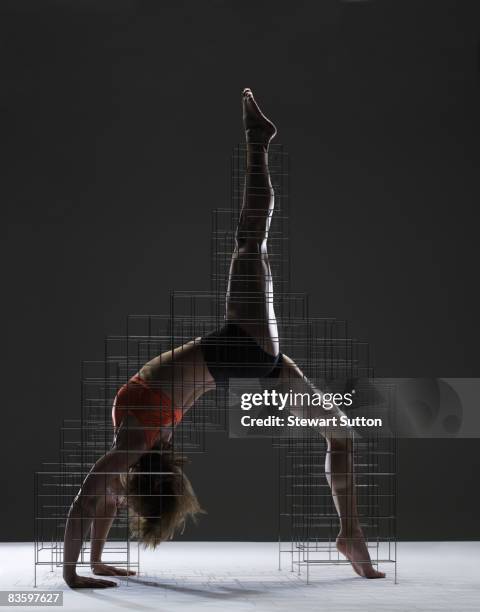 woman in yoga pose supported by armature - scaffolding stock pictures, royalty-free photos & images