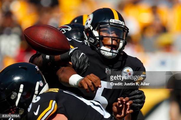 Joshua Dobbs of the Pittsburgh Steelers under pressure against the Atlanta Falcons during a preseason game at Heinz Field on August 20, 2017 in...