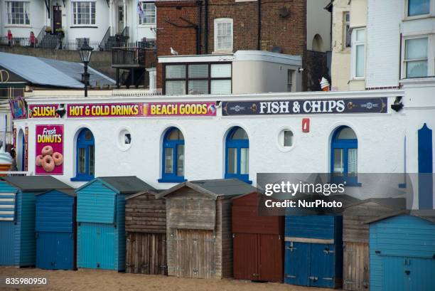 Beach huts are pictured close a fish and chips shop in Broadstairs in a summer Sunday, on August 20, 2017. Broadstairs is is a coastal town in the...