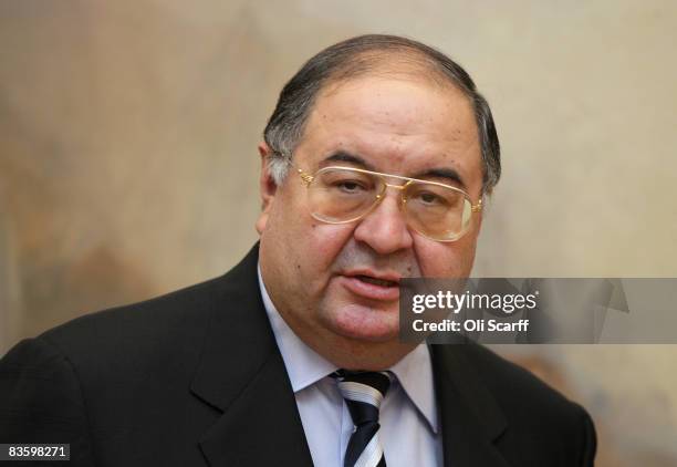 Russian Oligarch Alisher Usmanov is pictured in front of JMW Turner's painting ' The Harbour of Brest ' in the Tate Britain art gallery on November...