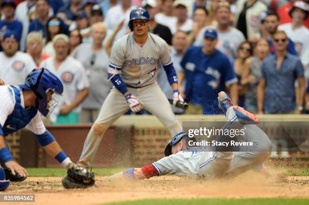 Josh Donaldson of the Toronto Blue Jays scores a run during the tenth inning of a game against the Chicago Cubs at Wrigley Field on August 20, 2017...