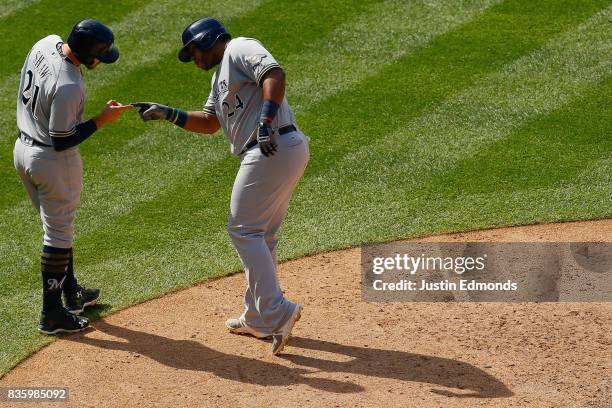 Jesus Aguilar of the Milwaukee Brewers celebrates his two-run home run with Travis Shaw during the seventh inning during the game against the...