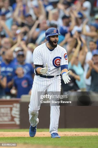 Alex Avila of the Chicago Cubs celebrates after hitting a walk off single to defeat the Toronto Blue Jays in the bottom of the 10th inning at Wrigley...