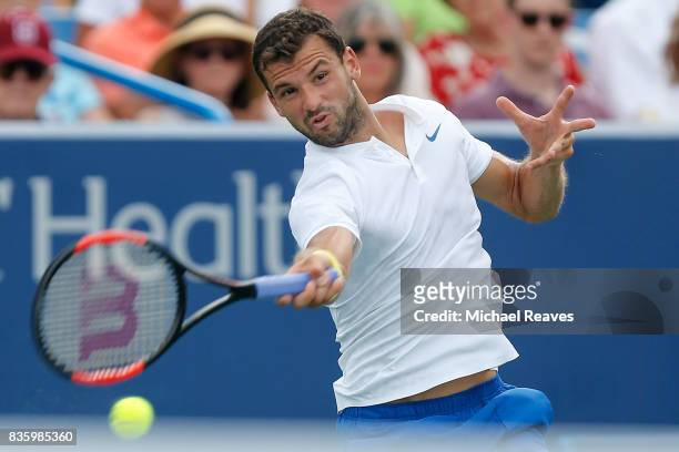 Grigor Dimitrov of Bulgaria returns a shot to Nick Kyrgios of Austrailia in the men's final on Day 9 of the Western and Southern Open at the Linder...