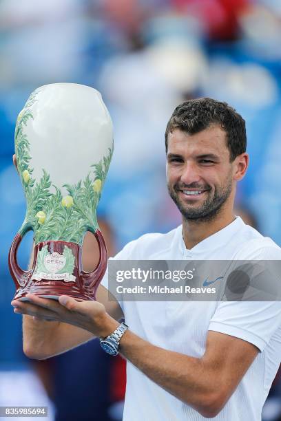 Grigor Dimitrov of Bulgaria holds up the trophy after defeating Nick Kyrgios of Austrailia in the men's final on Day 9 of the Western and Southern...