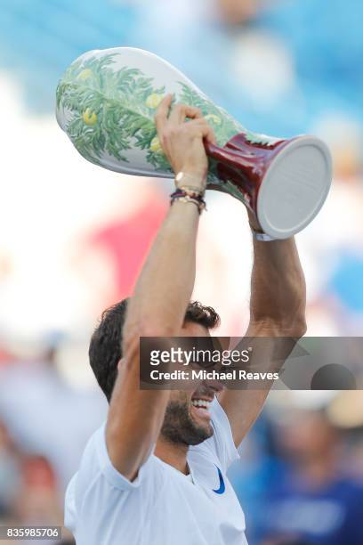 Grigor Dimitrov of Bulgaria holds up the trophy after defeating Nick Kyrgios of Austrailia in the men's final on Day 9 of the Western and Southern...