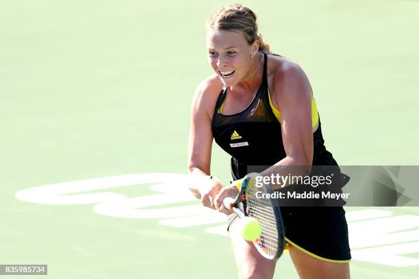 Anett Kontaveit of Estonia returns a shot to Mirjana Lucic-Baroni of Croatia during Day 3 of the Connecticut Open at Connecticut Tennis Center at...