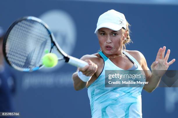 Yulia Putintseva of Kazakhstan returns a shot to Alize Cornet of France of during Day 3 of the Connecticut Open at Connecticut Tennis Center at Yale...
