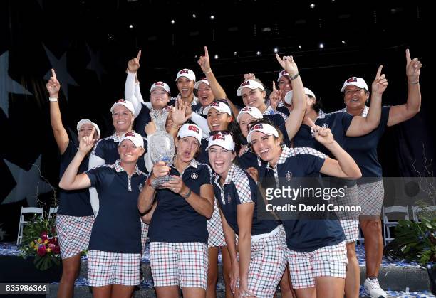 Juli Inkster the United States team captain holds the Solheim Cup with her team at the closing ceremony after the final day singles matches in the...