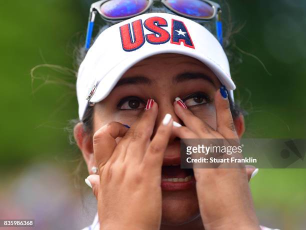 Lizette Salas of Team USA wipes away the tears on the 18th hole during the final day singles matches of The Solheim Cup at Des Moines Golf and...