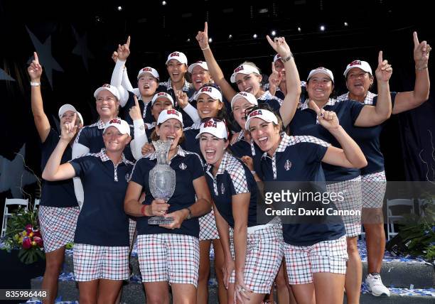Juli Inkster the United States team captain holds the Solheim Cup with her team at the closing ceremony after the final day singles matches in the...