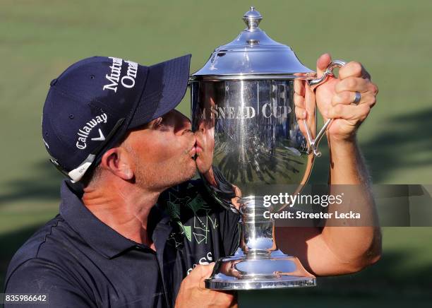 Henrik Stenson poses with the trophy after winning the Wyndham Championship during the final round at Sedgefield Country Club on August 20, 2017 in...