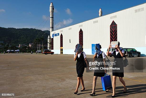 Stewardesses shelter from sunshine at the 7th China International Aviation and Aerospace Exhibition on November 7, 2008 in Zhuhai of Guangdong...