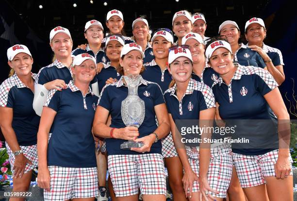 Team USA pose with the Solheim Cup after beating Team Europe 16 1/2 to 11 1/2 during closing ceremony of The Solheim Cup at Des Moines Golf and...