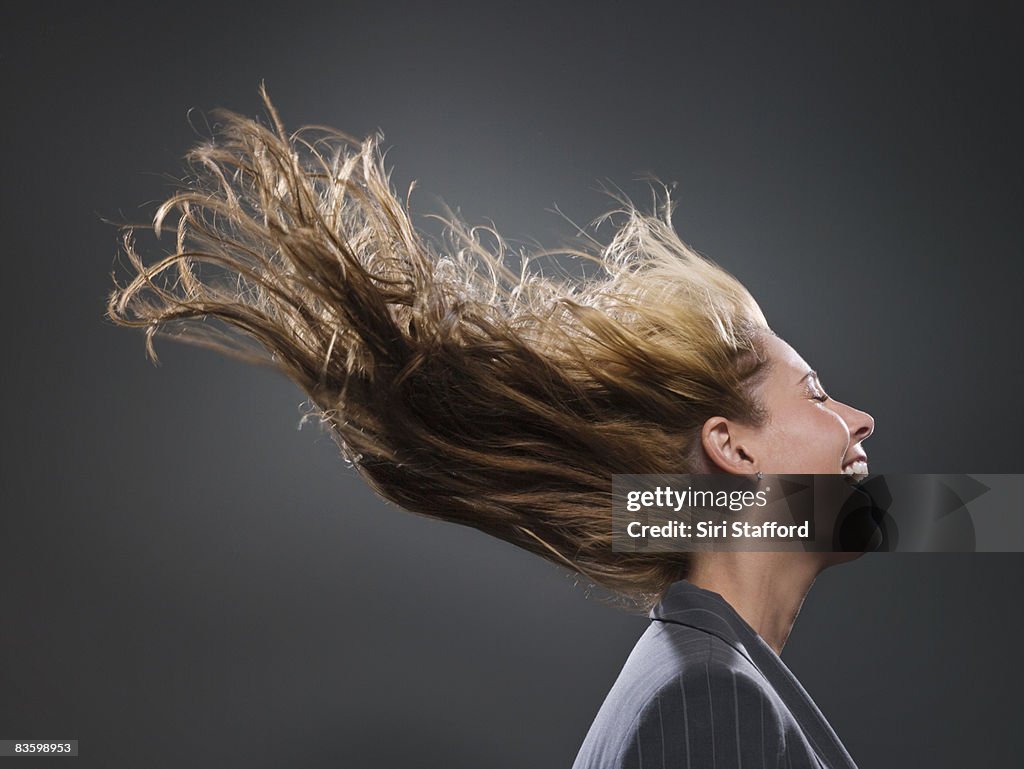 Businesswoman's hair blowing in wind