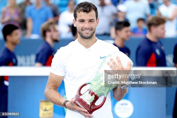 Grigor Dimitrov of Bulgaria poses for photographers after his win over Nick Kyrgios of Australia during the men's final on day 9 of the Western &...