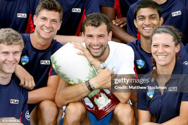 Grigor Dimitrov of Bulgaria poses for photographers with the ball persons after his win over Nick Kyrgios of Australia during the men's final on day...
