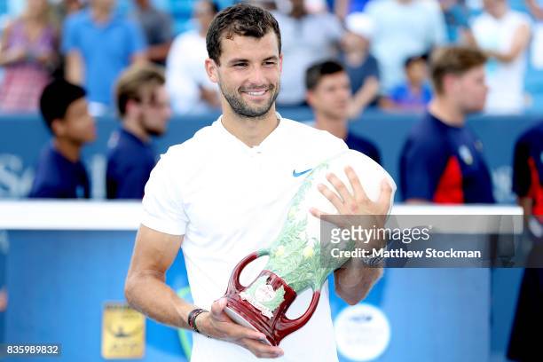 Grigor Dimitrov of Bulgaria poses for photographers after his win over Nick Kyrgios of Australia during the men's final on day 9 of the Western &...