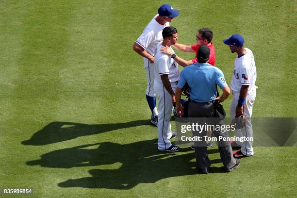 Matt Bush of the Texas Rangers leaves the game after colliding with Joey Gallo of the Texas Rangers while fielding the ball against the Chicago White...