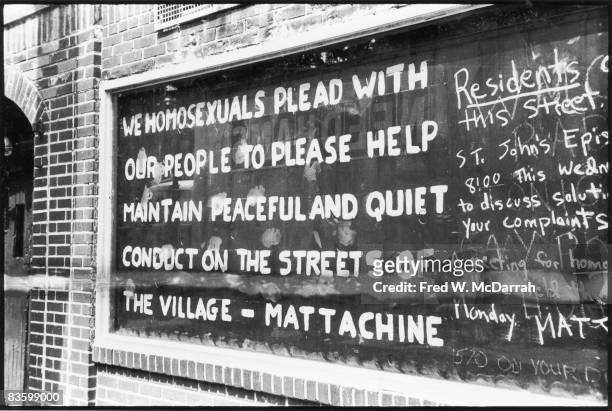 Hand-painted text on a boarded-up window of the Stonewall Inn after riots over the weekend of June 27, 1969. The text reads 'We homosexuals plead...