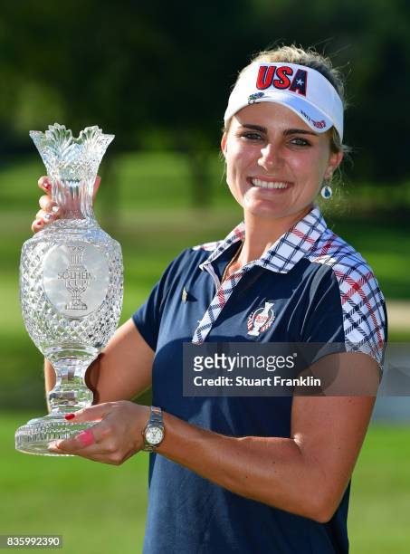 Lexi Trophy of Team USA holds the Solheim Cup trophy after the final day singles matches of The Solheim Cup at Des Moines Golf and Country Club on...