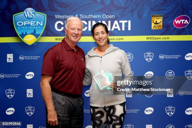 Wayne Richmond presents Garbine Muguruza of Spain with a special gift from the USTA after her win over Simona Halep of Romania during the women's...