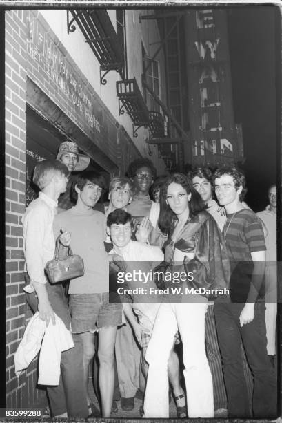 An unidentifed group of young poeple celebrate outside the boarded-up Stonewall Inn after riots over the weekend of June 27, 1969. The bar and...