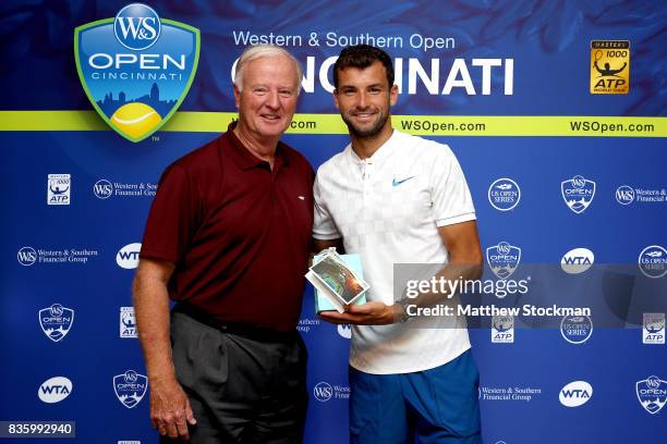 Wayne Richmond presents Grigor Dimitrov of Bulgaria a special gift from the USTA after his win over Nick Kyrgios of Australia during the men's final...