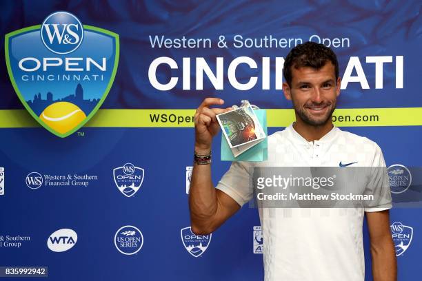 Grigor Dimitrov of Bulgaria is presented a special gift from the USTA after his win over Nick Kyrgios of Australia during the men's final on day 9 of...