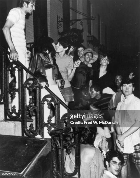 An unidentifed group of young poeple celebrate on a building stoop near the boarded-up Stonewall Inn after riots over the weekend of June 27, 1969....
