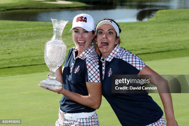 Paula Creamer of the United States Team holds the Solheim Cup as Gerina Piller enjoys a fun moment after the closing ceremony during the final day...