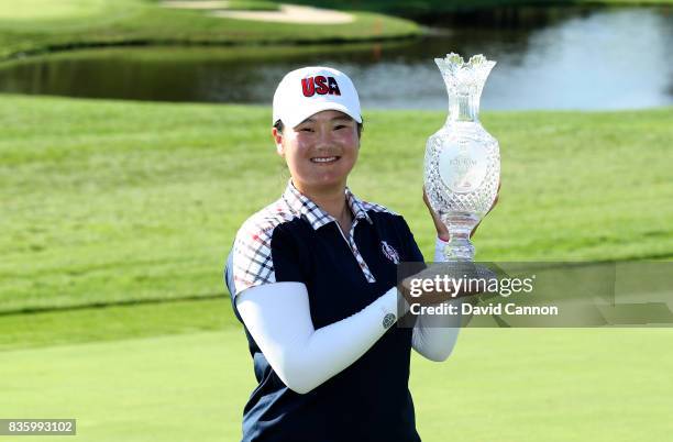 Angel Yin of the United States Team holds the Solheim Cup after the closing ceremony during the final day singles matches in the 2017 Solheim Cup at...