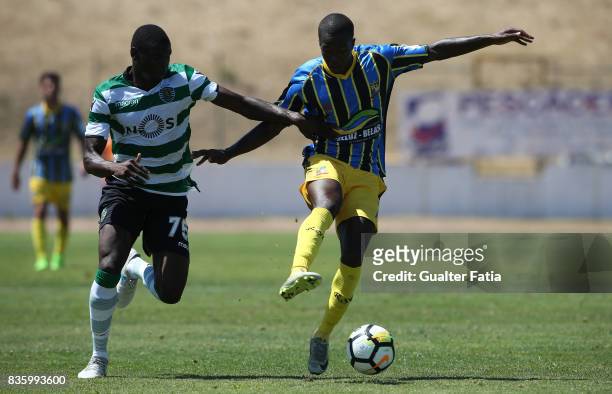 Real SC forward Marcos Barbeiro from Sao Tome and Principe with Sporting CP B defender Abdu Conte in action during the Segunda Liga match between...