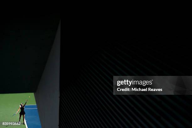 Garbine Muguruza of Spain serves to Simona Halep of Romania during the women's final on Day 9 of the Western and Southern Open at the Linder Family...