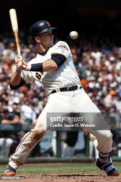 Buster Posey of the San Francisco Giants avoids an inside pitch from Ben Lively of the Philadelphia Phillies during the fourth inning at AT&T Park on...