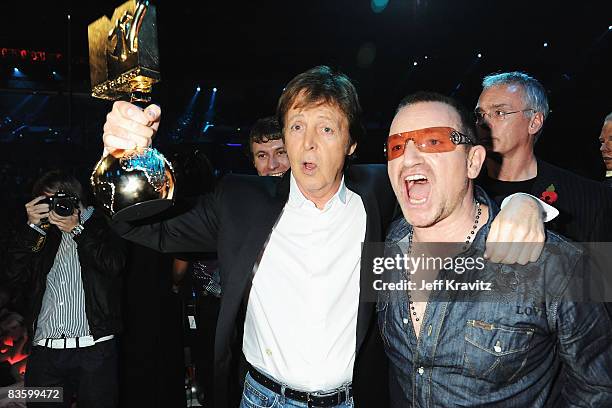 Sir Paul McCartney poses with his Ultimate Legend Award alongside Bono in the Glamour Pit at the 2008 MTV Europe Music Awards held at at the Echo...