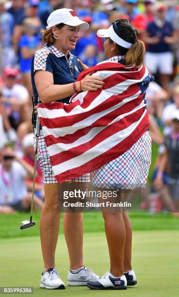 Juli Inkster, Captain of Team USA celebrates with Lizette Salas on the 18th hole during the final day singles matches of The Solheim Cup at Des...