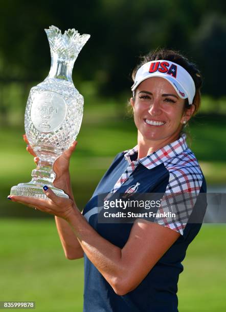 Gerina Piller of Team USA holds the Solheim Cup trophy after the final day singles matches of The Solheim Cup at Des Moines Golf and Country Club on...