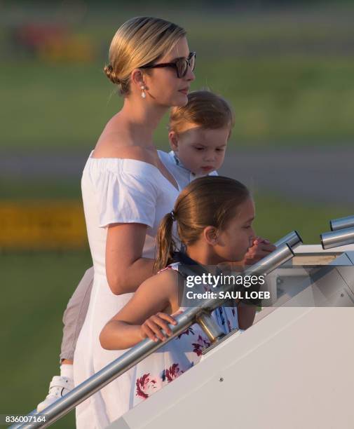 Ivanka Trump, daughter of US President Donald Trump, along with her children, Arabella and Theodore, board Air Force One prior to departure...