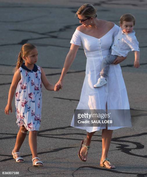 Ivanka Trump, daughter of US President Donald Trump, along with her children, Arabella and Theodore, walk to board Air Force One prior to departure...