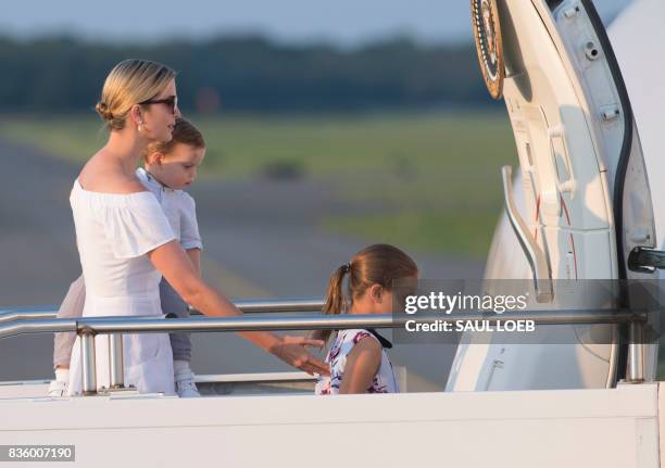 Ivanka Trump, daughter of US President Donald Trump, along with her children, Arabella and Theodore, board Air Force One prior to departure...