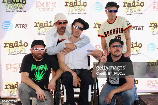 Jason Sechrist, John Gourley, Eric Howk, Kyle O'Quin and Zachary Carothers of the band Portugal. The Man pose with Solar Eclipse glasses at the Radio...
