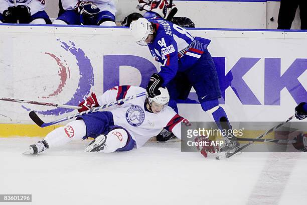 Norwegian Morten Ask vies for the puck with French Kevin Hecquefeuille in their ice hockey match Norway versus France at Jordal Amfi Stadium in Oslo,...